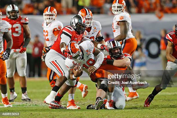 Tajh Boyd of the Clemson Tigers is sacked by the Ohio State Buckeyes during third quarter action during the 2014 Discover Orange Bowl at Sun Life...