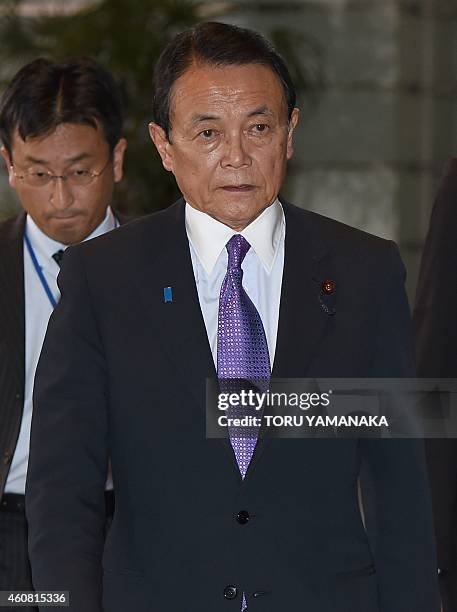 Japan's Finance and Deputy Prime Minister Taro Aso arrives at the prime minister's official residence in Tokyo on December 24, 2014. Japanese Prime...