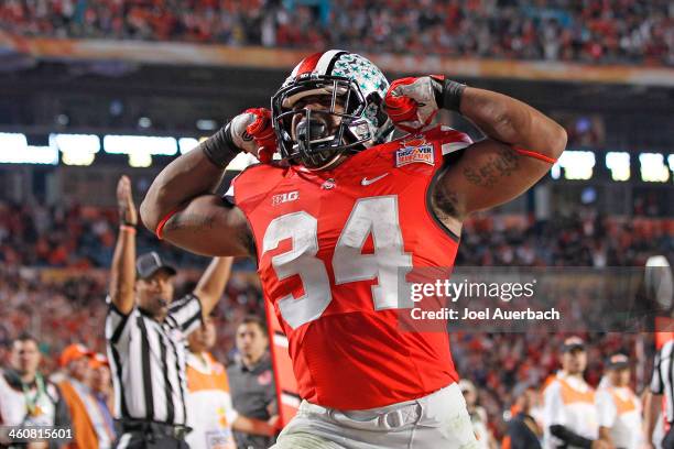 Carlos Hyde of the Ohio State Buckeyes celebrates his fourth quarter touchdown against the Clemson Tigers during the 2014 Discover Orange Bowl at Sun...