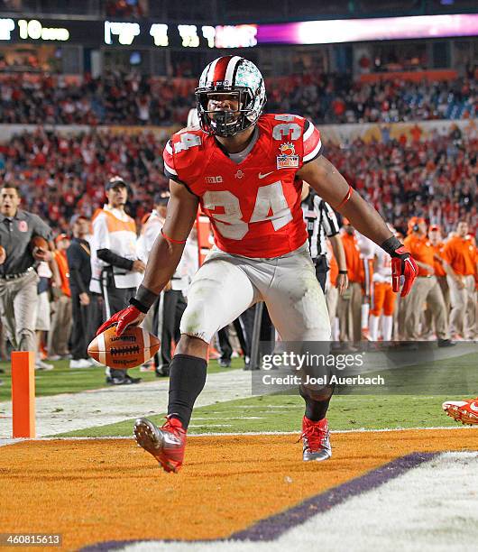 Carlos Hyde of the Ohio State Buckeyes celebrates his fourth quarter touchdown against the Clemson Tigers during the 2014 Discover Orange Bowl at Sun...