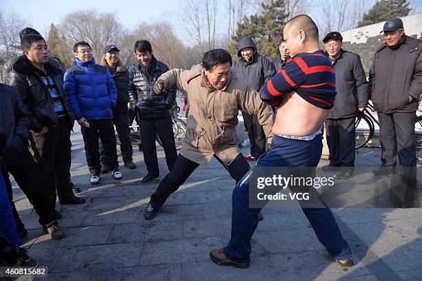 Iron Belly" man, Guo Haijun, invites onlookers to punch him in the stomach on December 23, 2014 in Shenyang, Liaoning province of China.