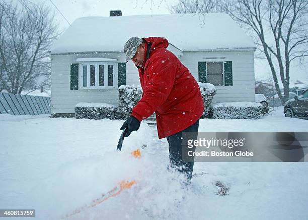 Lawrence mayor-elect Daniel Rivera shovels snow at his home on Thursday afternoon as a winter storm covered Massachusetts.