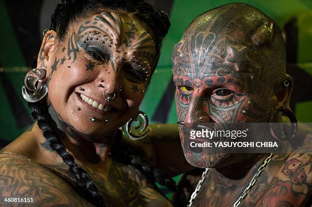 Uruguayan tatoo artist Victor Hugo Peralta and his wife, Argentinian tatoo artist Gabriela Peralta pose for a picture during the Tatoo Week Rio in...