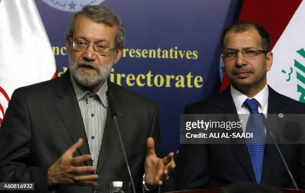 Iraqi Parliament's speaker Salim al-Juburi stands next to his Iranian counterpart Ali Larijani speaking during a press conference following a meeting...