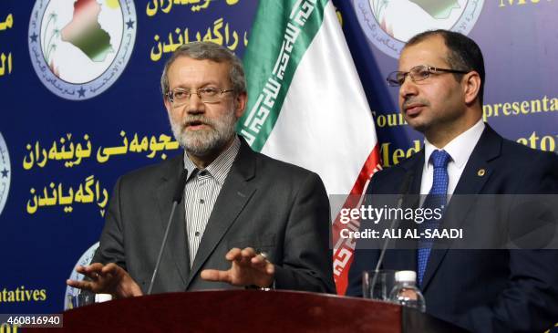 Iraqi Parliament's speaker Salim al-Juburi stands next to his Iranian counterpart Ali Larijani during a press conference following a meeting on...