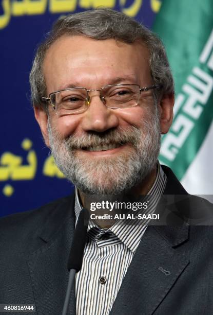 Iranian Parliament's speaker Ali Larijani smiles during a joint press conference with his Iraqi counterpart Salim al-Juburi following a meeting on...