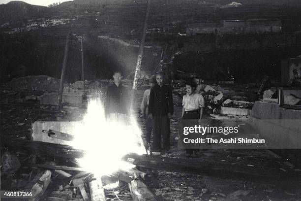 Family members cremate the body of a victim of the atomic bombing of Nagasaki, Japan, circa September 1945. The world's first atomic bomb was dropped...