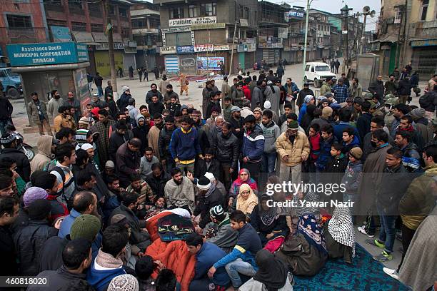 Supporters and activists of Jammu and Kashmir Liberation Front comfort the chairman of JKLF Yasin Malik after Indian government forces fired teargas...