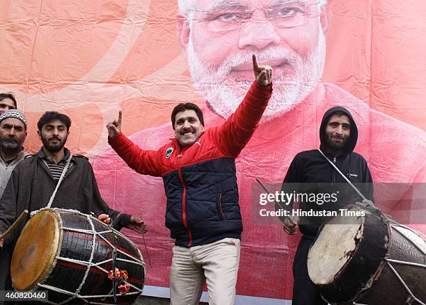 Bharatiya Janata Party supporters dance to celebrate their victory in the Jammu and Kashmir Assembly elections at party Headquarters on December 24,...