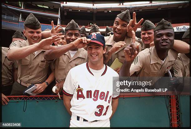 Chuck Finley of the California Angels stands with military personal before a game at Anaheim Stadium in Anaheim, California. Chuck Finley played for...
