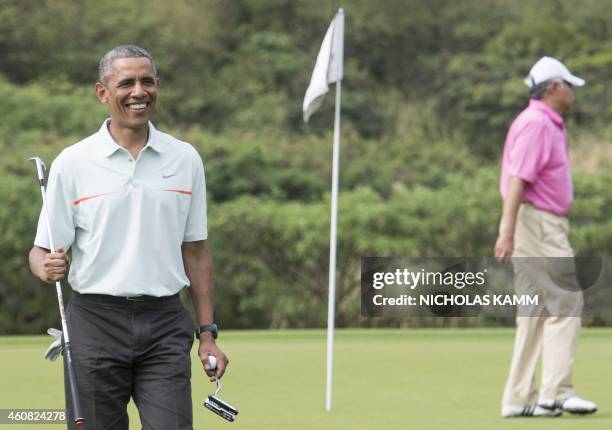 President Barack Obama talks to reporters as he plays golf with Malaysian Prime Minister Najib Razzak at Marine Corps Base Hawaii on December 24,...