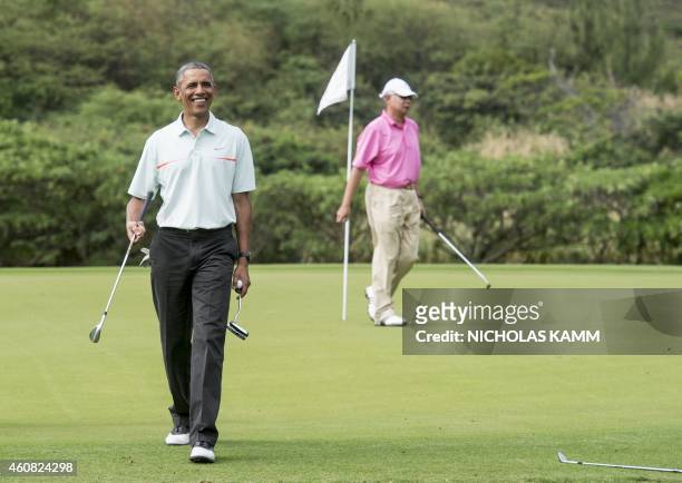President Barack Obama talks to reporters as he plays golf with Malaysian Prime Minister Najib Razzak at Marine Corps Base Hawaii on December 24,...