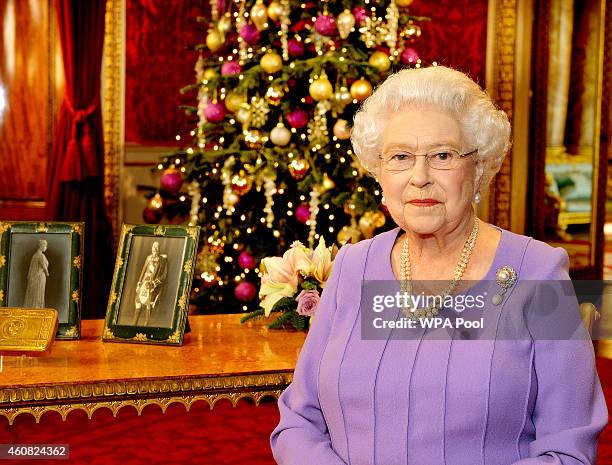 Britain's Queen Elizabeth II poses in the State Dining Room of Buckingham Palace after recording her Christmas Day television broadcast to the...