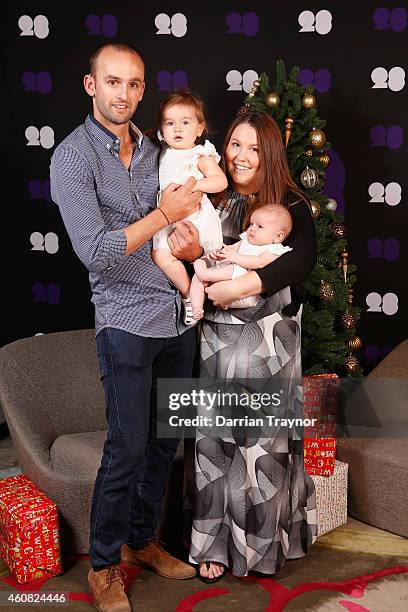 Nathan Lyon and his partner Mel Waring pose for a photo with their children Milla and Harper during an Australian Test squad Christmas Lunch at...