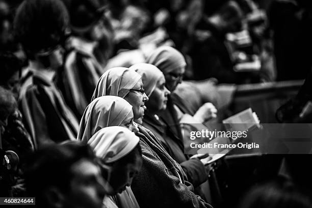 Nuns attend the Christmas night mass held by Pope Francis at St. Peter's Basilica on December 24, 2014 in Vatican City, Vatican.