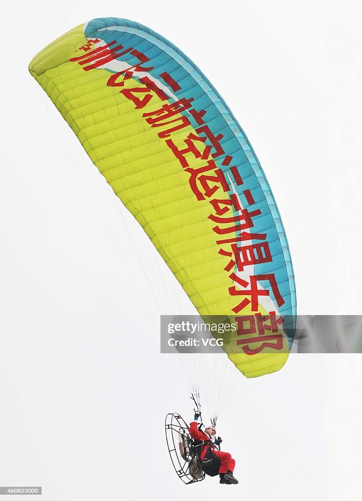 Youngsters Dressed As Santa Claus Drive Powered Paragliding In Guiyang