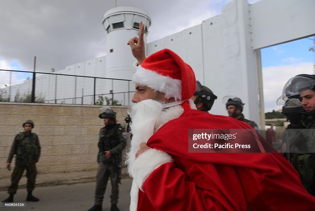 Palestinian protester dressed as Santa Claus argues with the...