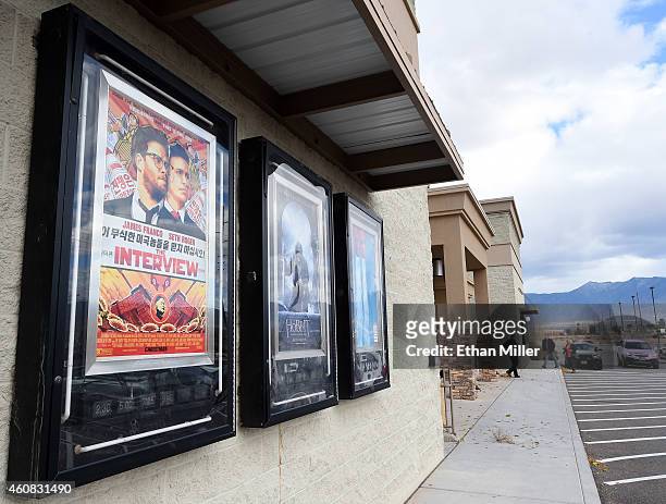 Movie posters, including one for "The Interview," are displayed outside the Megaplex Theatres - Stadium 6 as the Sony Pictures' film opens on...