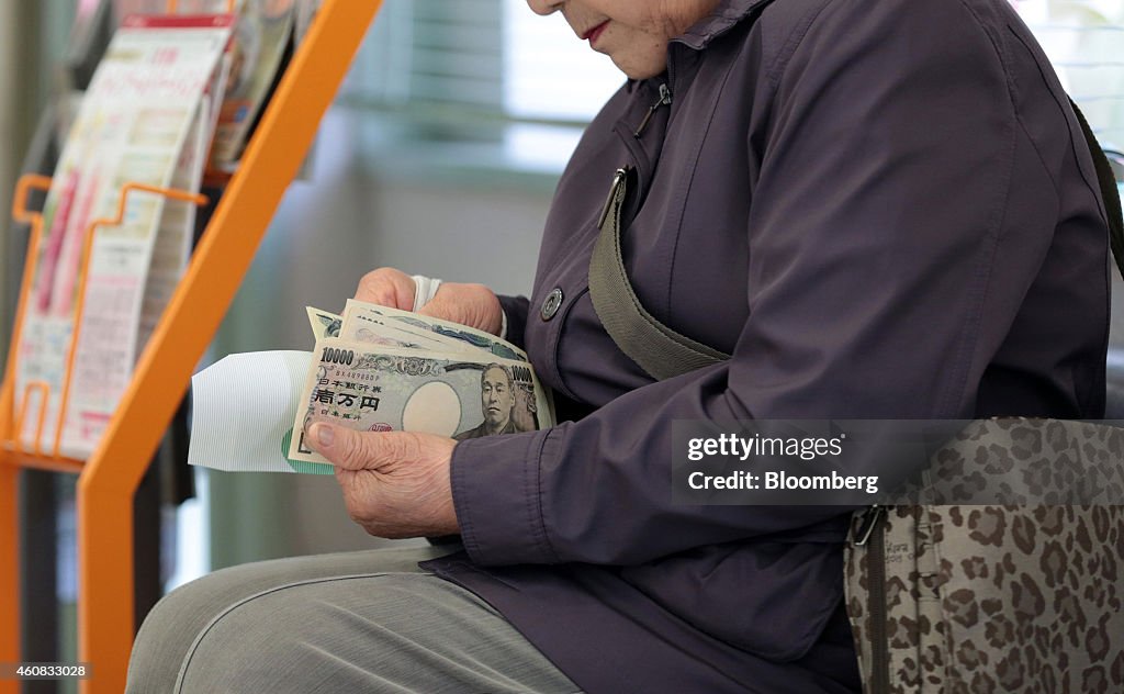 A customer counts her money after making a withdrawal at a 