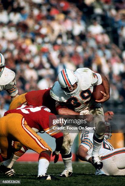 Larry Csonka of the Miami Dolphins fights off the tackle of Rosey Taylor of the Washington Redskins during Super Bowl VII at the Los Angeles Memorial...