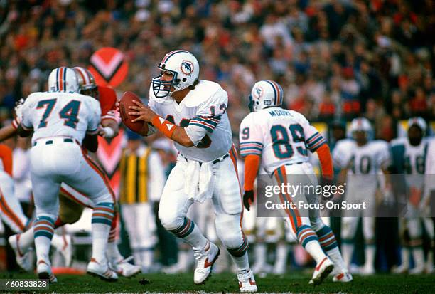 Dan Marino of the Miami Dolphins rolls out to pass against the San Francisco 49ers during Super Bowl XIX on January 20, 1985 at Stanford Stadium in...