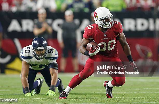 Running back Stepfan Taylor of the Arizona Cardinals rushes the football past outside linebacker K.J. Wright of the Seattle Seahawks during the NFL...