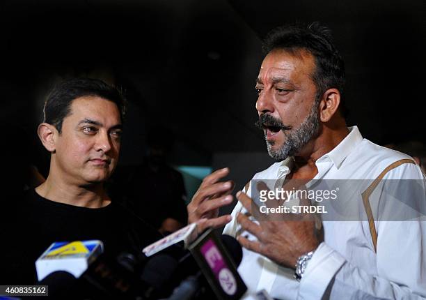 Indian Bollywood actor Sanjay Dutt , on two weeks furlough from his prison sentence, speaks to journalists with actor Aamir Khan as they attend a...