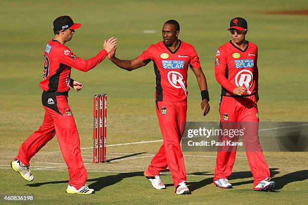 Ben Rohrer of the Renegades congratulates Dwayne Bravo after dismissing Michael Carberry of the Scorchers during the Big Bash League match between...