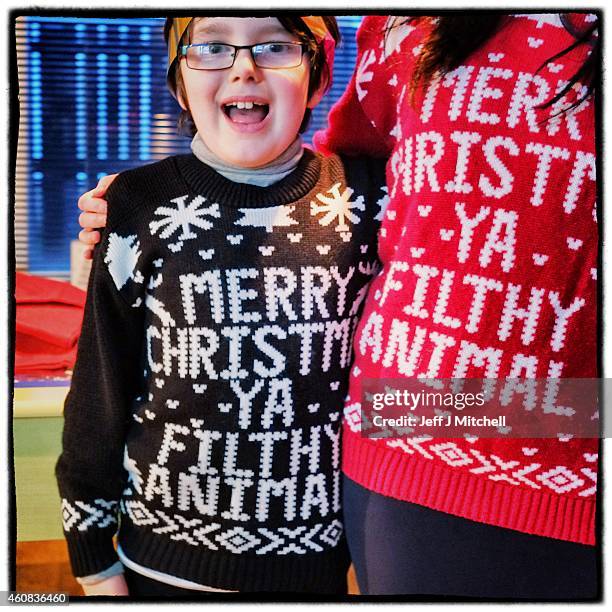 Two children wear Christmas jumpers on December 25, 2014 in Glasgow, Scotland. Millions of people across the UK spend time with family and loved ones...