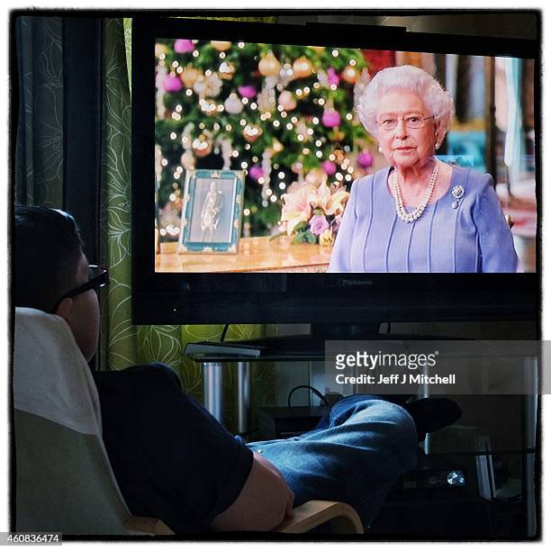 Boy watches Queens Christmas day speech on December 25, 2014 in Glasgow, Scotland. Millions of people across the UK spend time with family and loved...