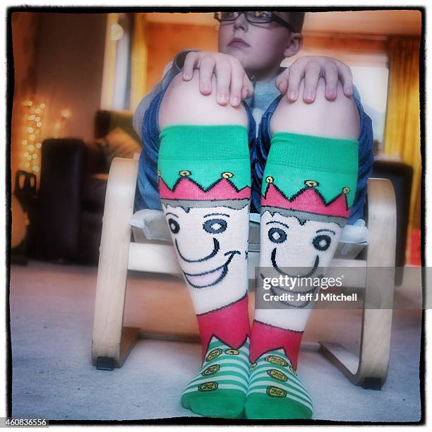 Boy wears a pair of Christmas sock on December 25, 2014 in Glasgow, Scotland. Millions of people across the UK spend time with family and loved ones...