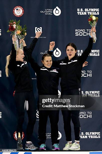 Emily Scott, Jessica Smith and Alyson Dudek celebrate on the medals podium after ladies 1,000 meter final during the U.S. Olympic Short Track Trials...