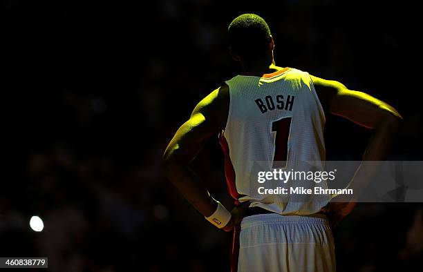 Chris Bosh of the Miami Heat looks on during a a game against the Toronto Raptors at AmericanAirlines Arena on January 5, 2014 in Miami, Florida....