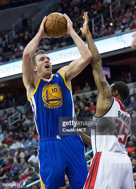 Golden State Warriors power forward David Lee shoots over Washington Wizards power forward Trevor Booker during the first half of their game played...