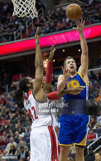 Golden State Warriors power forward David Lee shoots over Washington Wizards power forward Nene Hilario during the first half of their game played at...