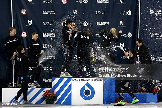 Members of the U.S. Short Track ladies team Alyson Dudek, Jessica Smith and Emily Scott are sprayed with champagne by members of the men's team Chris...