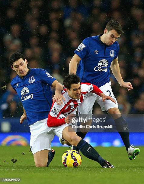 Bojan Krkic of Stoke City tangles with Gareth Barry and Seamus Coleman of Everton during the Barclays Premier League match between Everton and Stoke...