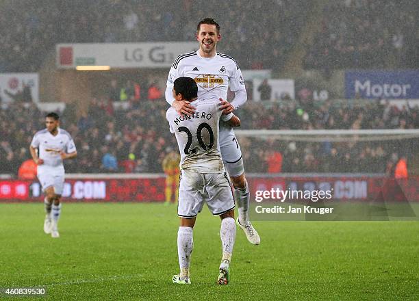 Gylfi Sigurdsson of Swansea City celebrates with Jefferson Montero as he scores their first goal during the Barclays Premier League match between...