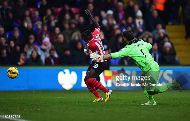 Sadio Mane of Southampton evades goalkeeper Julian Speroni of Crystal Palace to score their first goal during the Barclays Premier League match...