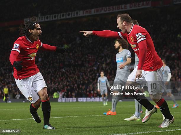 Wayne Rooney of Manchester United celebrates scoring their first goal during the Barclays Premier League match between Manchester United and...