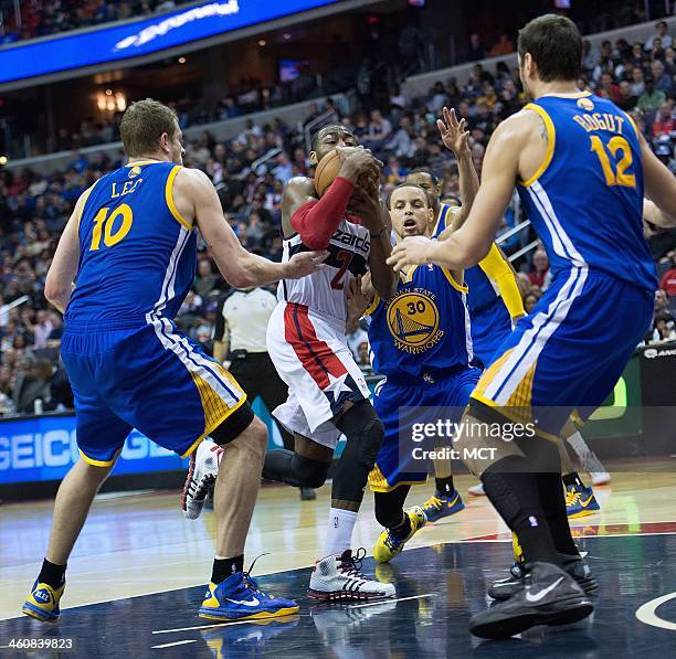 Washington Wizards point guard John Wall is surrounded by Golden State Warriors power forward David Lee , center Andrew Bogut and point guard Stephen...