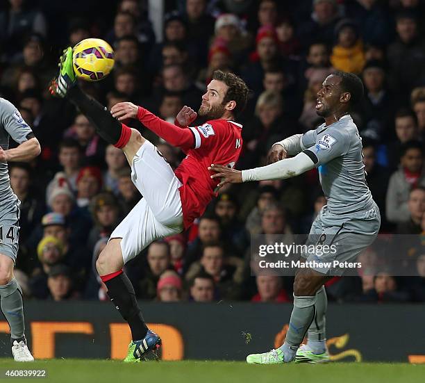 Juan Mata of Manchester United in action with Vurnon Anita of Newcastle United during the Barclays Premier League match between Manchester United and...