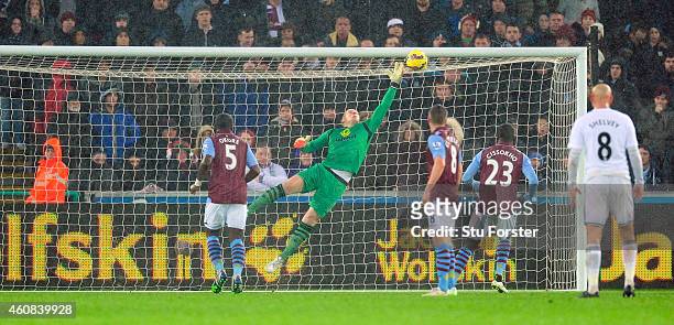 Villa goalkeeper Brad Guzan is beaten by a free kick from Gylfi Sigurdsson for the first goal during the Barclays Premier League match between...
