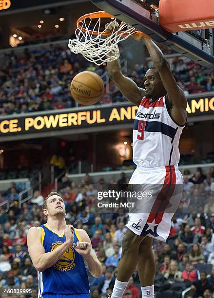 Washington Wizards small forward Martell Webster slam dunks while Golden State Warriors power forward David Lee looks on during the second half of...
