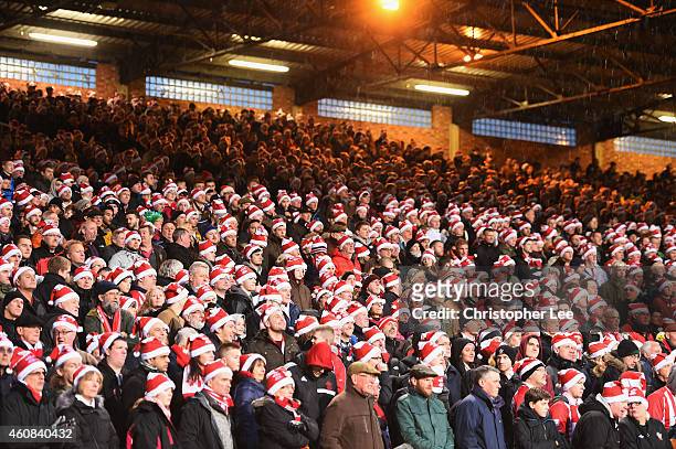 Fans wear 'Father Christmas' style hats during the Barclays Premier League match between Crystal Palace and Southampton at Selhurst Park on December...