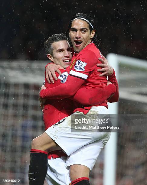 Robin van Persie of Manchester United celebrates scoring their third goal during the Barclays Premier League match between Manchester United and...