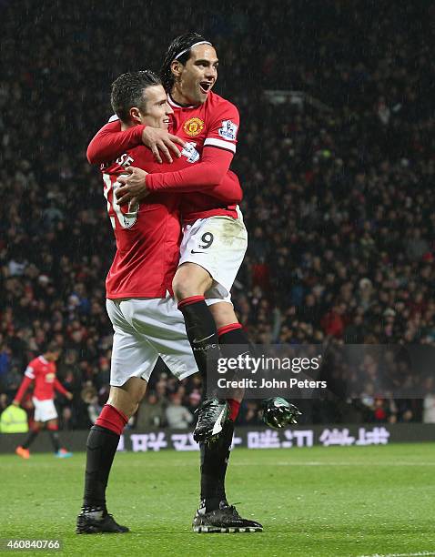 Robin van Persie of Manchester United celebrates scoring their third goal during the Barclays Premier League match between Manchester United and...