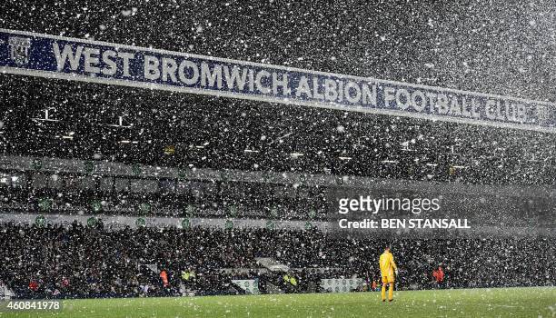West Bromwich Albion's English goalkeeper Ben Foster stands as the snow falls during the English Premier League football match between West Bromwich...