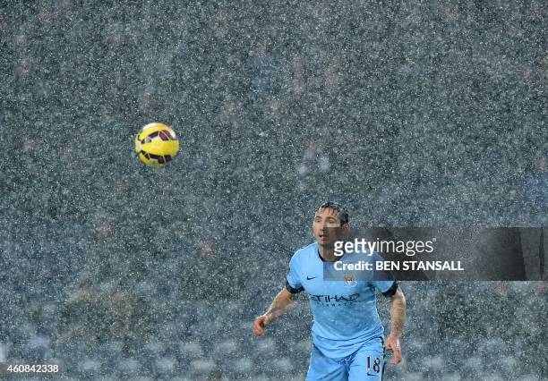 Manchester City's English midfielder Frank Lampard watches the ball through a snow shower during English Premier League football match between West...
