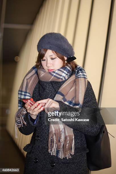young female typing messages on a smart phone - plaid scarf stock pictures, royalty-free photos & images